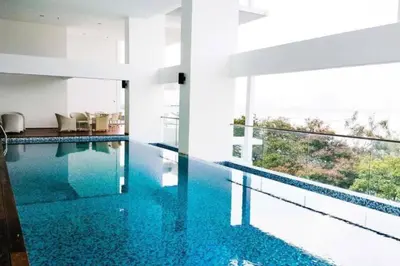a swimming pool with blue water in a house at Seaview Premium Duplex in Gurney with WiFi & Full Kitchen 12B in George Town
