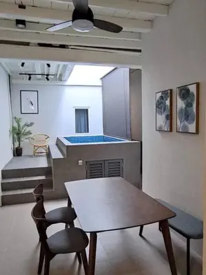 a dining room with a table and two chairs at Heritage House 2BR with Dipping Pool in Town walkto Street Art 45 in George Town