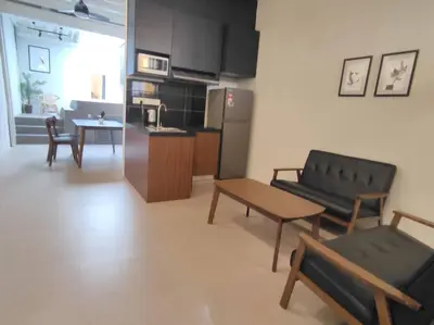 a living room with a couch and a table and a kitchen at Heritage House 2BR with Dipping Pool in Town walkto Street Art 45 in George Town