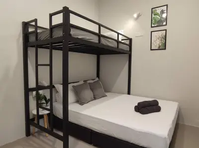 a bedroom with a bunk bed with a white mattress at Heritage House 2BR with Dipping Pool in Town walkto Street Art 47 in George Town