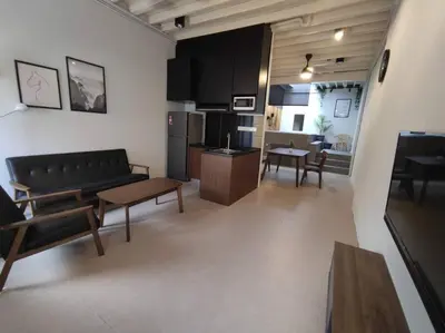 a living room with a couch and a table at Heritage House 2BR with Dipping Pool in Town walkto Street Art 47 in George Town
