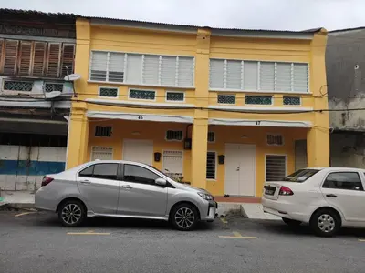 two cars parked in a parking lot in front of a building at Heritage House 2BR with Dipping Pool in Town walkto Street Art 47 in George Town