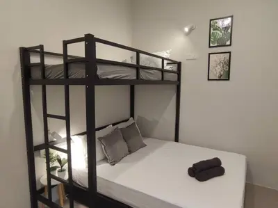 a bedroom with a bunk bed with a white mattress at Heritage House 2BR with Dipping Pool in Town walkto Street Art 47 in George Town