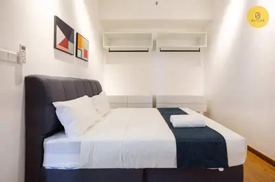 a bedroom with a bed with a blue and white blanket at Seaview 2BR Infinity Pool & EasyAccess to Town 13A in George Town