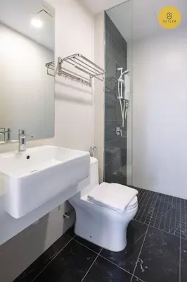 a white bathroom with a sink and a toilet at Seaview 2BR Infinity Pool & EasyAccess to Town 191 in George Town