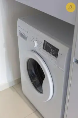 a white washing machine in a room with a counter at Seaview 2BR Infinity Pool & EasyAccess to Town 191 in George Town
