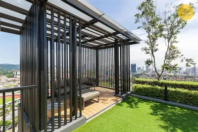 a pergola with a chair on a balcony at Seaview 2BR Infinity Pool & EasyAccess to Town 201 in George Town