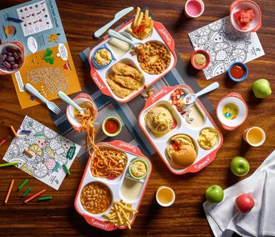 a table with three trays of food on it at Holiday Inn & Suites Penang Prai by IHG in Bukit Mertajam