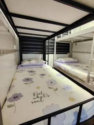 two bunk beds in a room with at The Family Hideaway 2 Bedroom Apartment at Equatorial Hill Resort in Brinchang