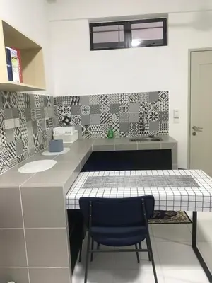 a kitchen with a counter and a blue chair at DyMaz Salam Homestay in Seri Iskandar