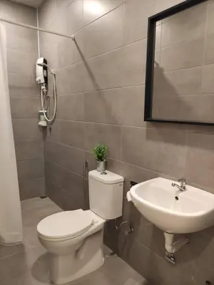 a bathroom with a toilet and a sink at Heritage House 4BR with Dipping Pool, Central Location Near Street Art 45 in George Town