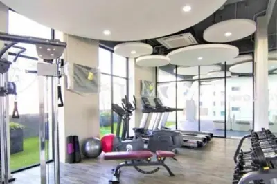 a gym with several treadmills and elliptical machines at JazzSuite Muji Seafront unit NearStraitsQuay in Tanjong Tokong
