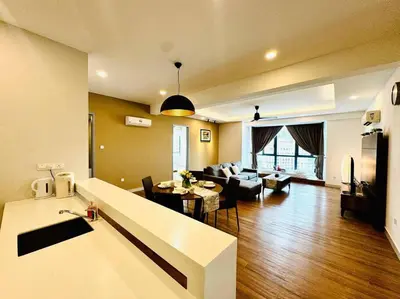 a living room with a couch and a table in a room at JazzSuite Muji Seafront unit NearStraitsQuay in Tanjong Tokong