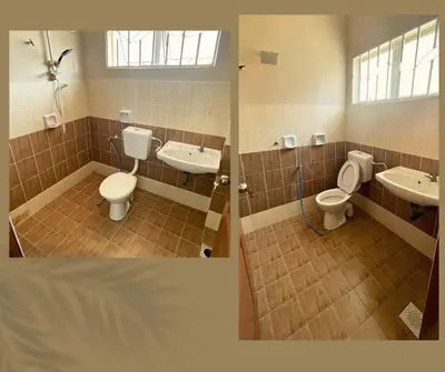 a bathroom with two sinks and a toilet at Santai Impian Meru Ipoh in Ipoh