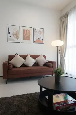 a living room with a couch and a table at Urban Suites Infinity Pool 3BR 2Carparks 8pax in Jelutong