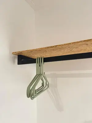 a metal hook hanging from a shelf on a wall at Cozy Roomstay Teluk Intan in Teluk Intan
