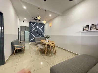 a dining room with a table and chairs in a room at Cozy Roomstay Teluk Intan in Teluk Intan