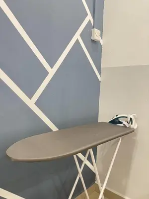 a surfboard sitting on a stand next to a wall at Cozy Roomstay Teluk Intan in Teluk Intan