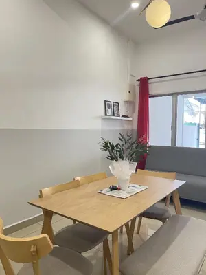 a wooden table and chairs in a room at Cozy Roomstay Teluk Intan in Teluk Intan