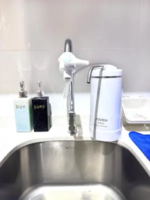 a sink with a faucet on a kitchen counter at Decozy 9 Ipoh Town Condo 12pax in Ipoh