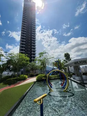 a water slide in a park with a tall building at Urban Suites - Queens Suite in Jelutong
