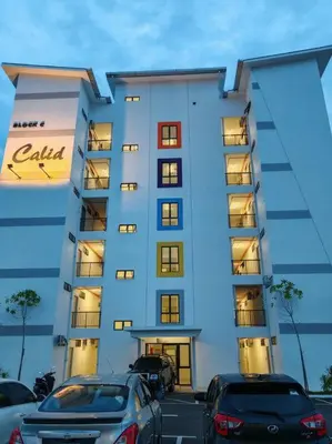 a large building with cars parked in front of it at Comfortable Greenery in Seri Iskandar
