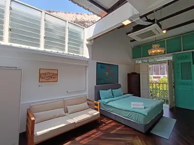 a living room with a couch and a bed at The Georgetown Green Gates in George Town