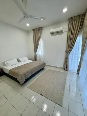 a bedroom with a bed in a white room at Rimbayu 81 in Kampung Bota Kiri
