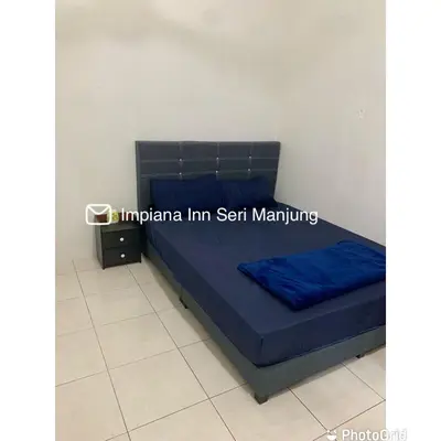 a bed with a blue mattress in a room at Impiana Inn Seri Manjung in Seri Manjung