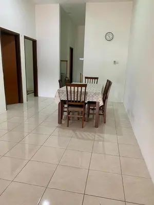 a dining room with a table and chairs on a tile floor at Impiana Inn Seri Manjung in Seri Manjung
