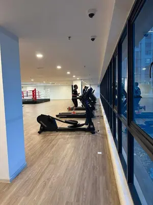 a gym with people exercising in a room with a pool at Apartment in Batu Kawan in Batu Kawan