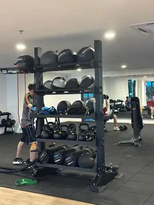 a man in a gym with a rack full of weights at Apartment in Batu Kawan in Batu Kawan