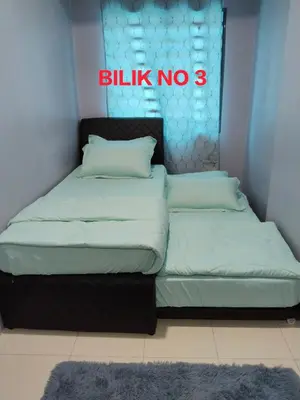 two beds in a room with a sign that reads billiken no at Homestay Lyn Impian in Tanjung Rambutan
