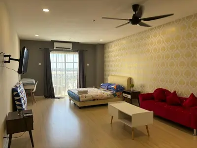 a living room with a bed and a red couch at KF Homestay Premium Suite in Kampar