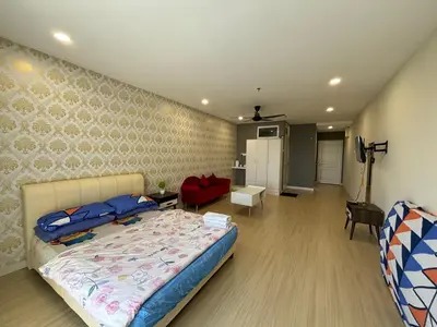 a bedroom with a bed and a living room at KF Homestay Premium Suite in Kampar