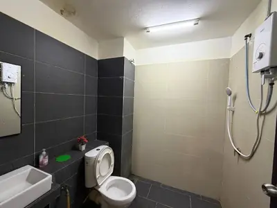 a bathroom with a toilet and a sink and a shower at D'Anggun Studio in Gua Musang