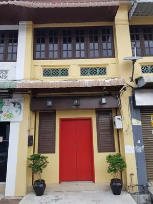 a yellow and red building with a red door at Heritage Studio in UNESCO Zone near to StreetArt & Town 2 in George Town