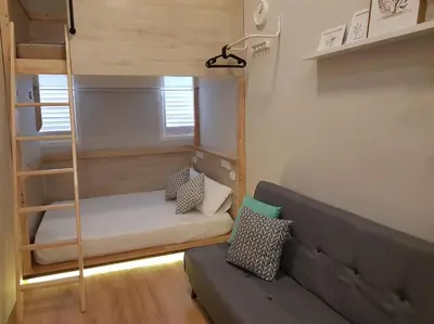 a living room with a couch and a bunk bed at Heritage Loft on Beach Street near UNESCO Zone & Street Art 2 in George Town