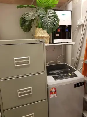 a kitchen with a refrigerator and a plant on a shelf at Heritage Loft on Beach Street near UNESCO Zone & Street Art 2 in George Town