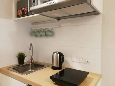a kitchen with a sink and a counter top at Heritage Loft on Beach Street near UNESCO Zone & Street Art 3 in George Town