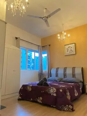 a bedroom with a bed and a ceiling fan at Nature's Sanctuary at Tanah Rata in Tanah Rata