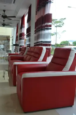 a row of red leather couches in a room at DR Hotel Penang in Bayan Lepas