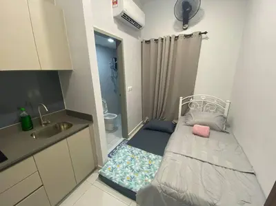 a small bedroom with a bed and a sink at Mini Studio in Batu Kawan in Batu Kawan