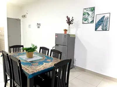a dining room with a table and a refrigerator at Ammara Homestay 3 Palas horizon Kea Farm in Cameron Highlands