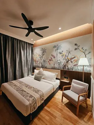 a bedroom with a bed and a ceiling fan at The Palm Suite at Lava Mansion in George Town