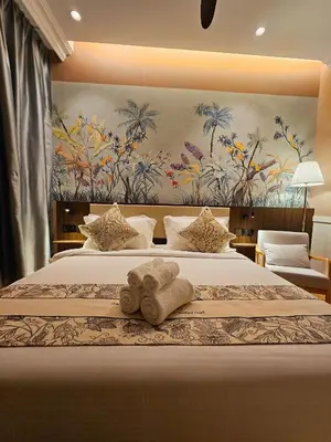 a hotel room with a bed with a towel on it at The Palm Suite at Lava Mansion in George Town