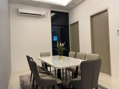 a dining room with a white table and chairs at Rumah teres untuk keluarga in Tanjung Rambutan