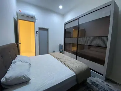 a bedroom with a large bed in a room at Rumah teres untuk keluarga in Tanjung Rambutan