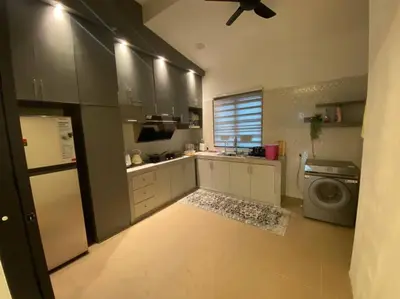 a kitchen with a refrigerator and a washing machine at Rumah teres untuk keluarga in Tanjung Rambutan