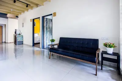 a black couch sitting in a room at Plumeria 5BR Garden House by uBook in Butterworth